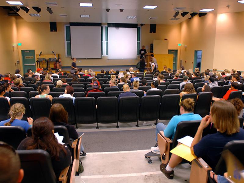 view from behind of students seated in theater style seats